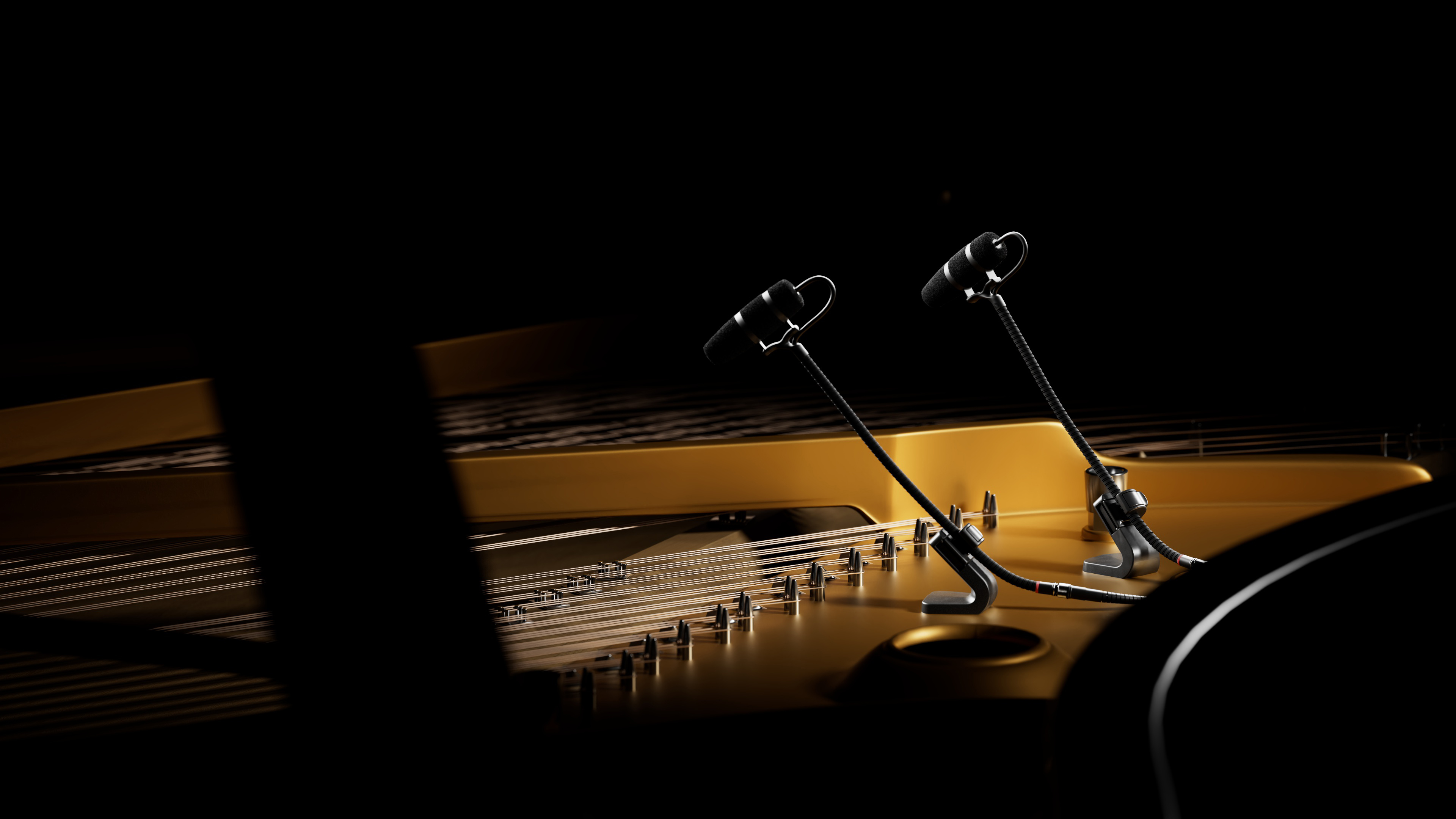 A close view of a grand piano being miked, illustrating microphone placement technique.